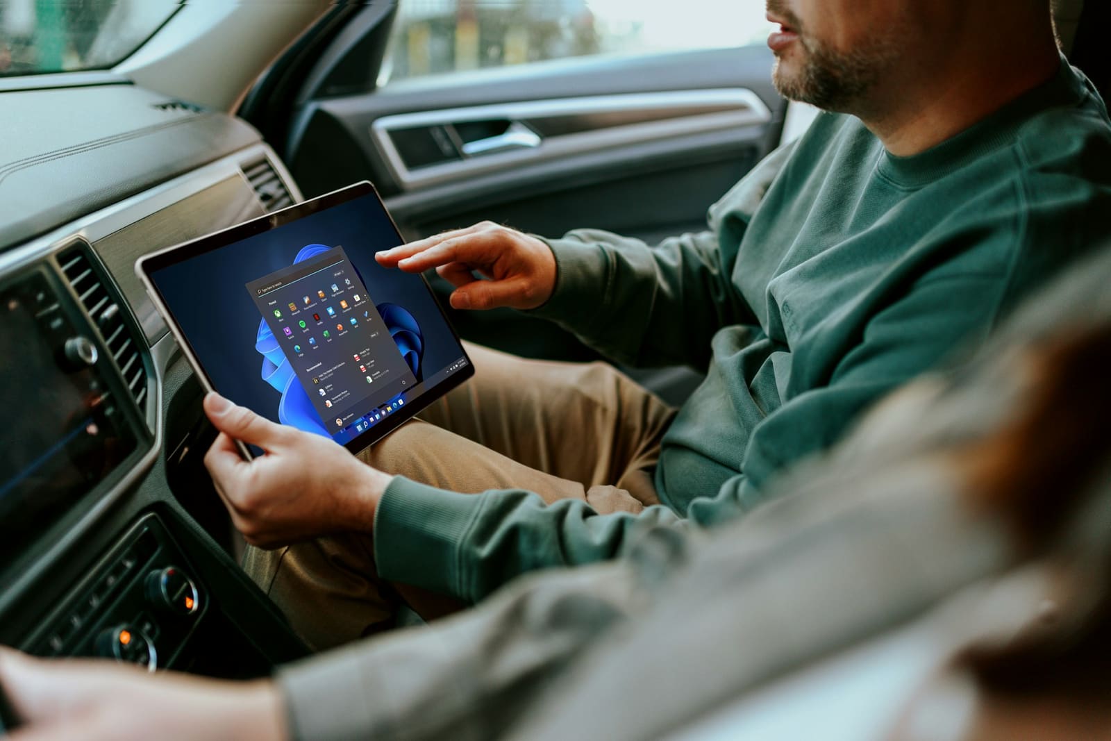 An inspector using a tablet inside a car