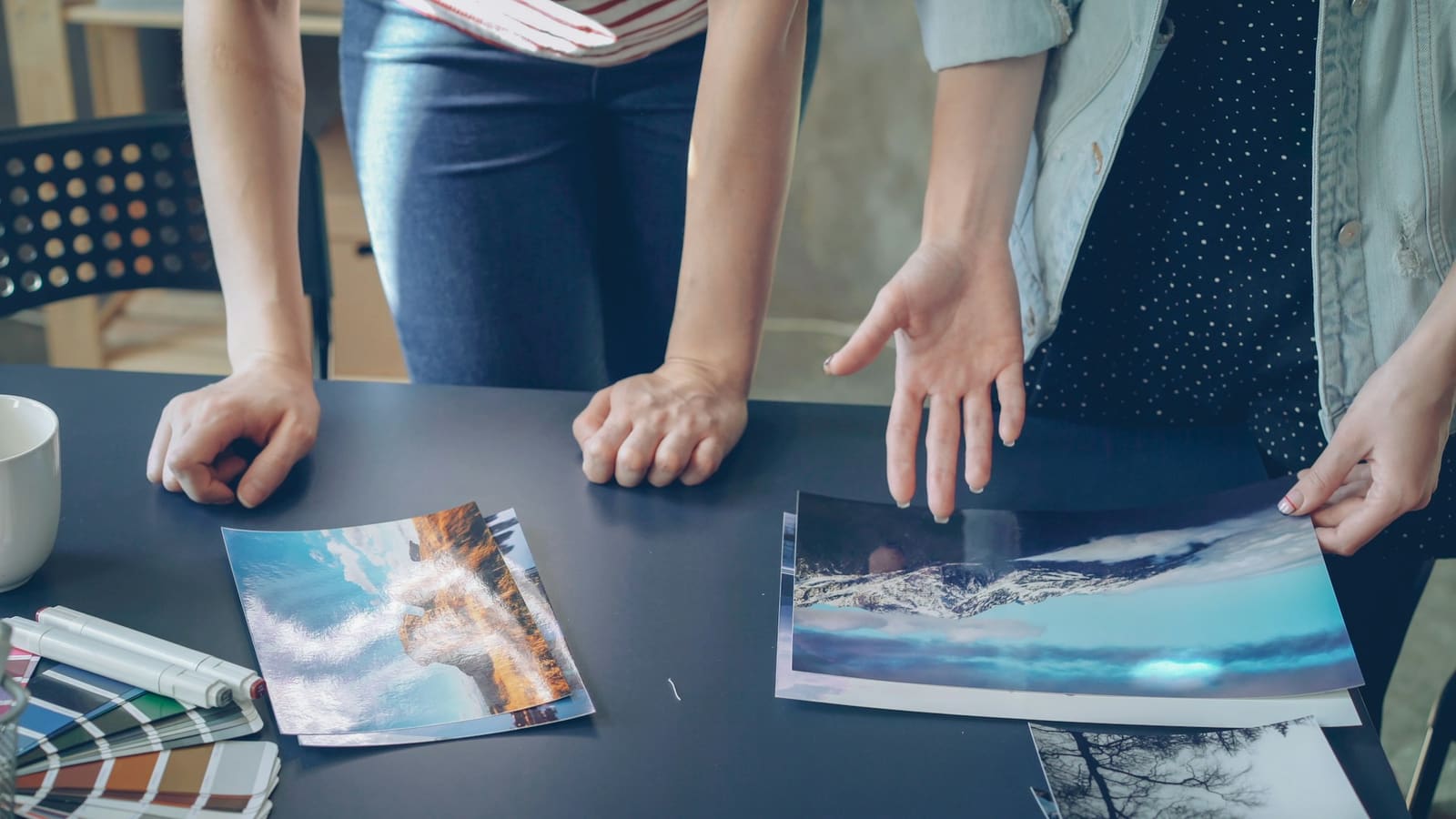 Clients choosing between printed photographs on a table